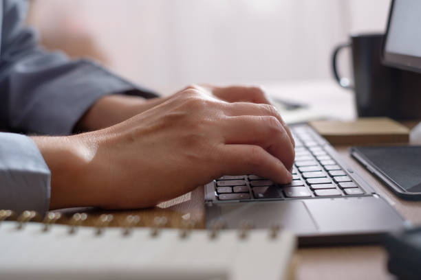 istock close up hand typing on keyboard when woking at home 1421194075