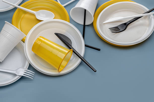 istock A set of multi-colored plastic utensils on a gray background, top view. 1421196302