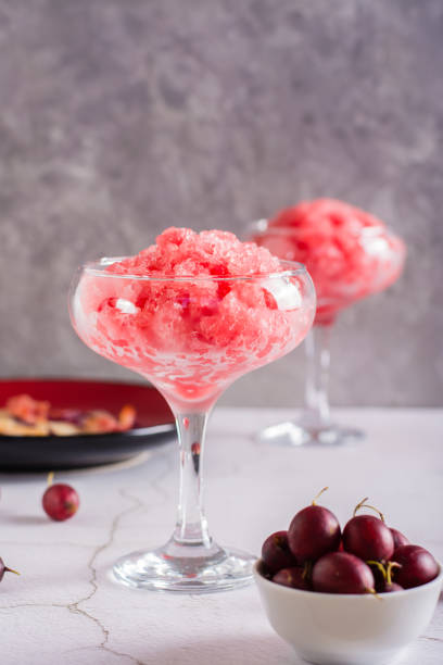 Summer drink frozen wine slushy in glasses on table. Refreshing alcoholic cocktail. Vertical view Summer drink frozen wine slushy in glasses on the table. Refreshing alcoholic cocktail. Vertical view frozen rose stock pictures, royalty-free photos & images
