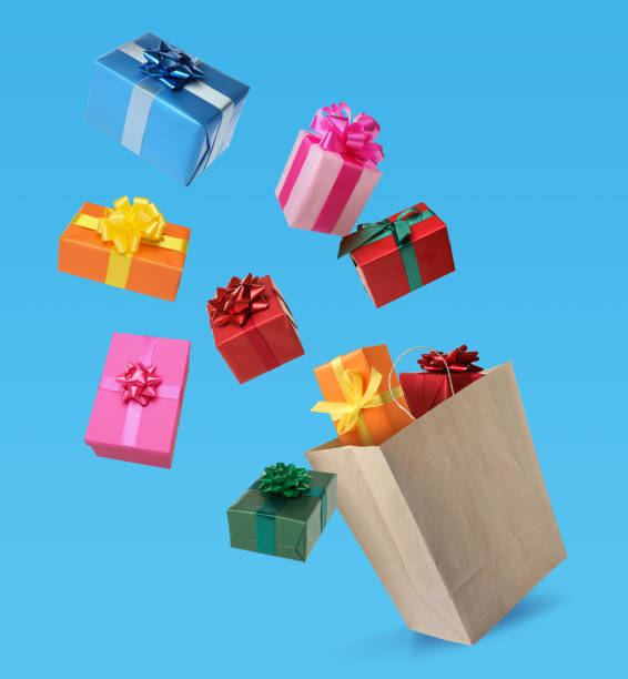 istock Many different gift boxes falling into paper shopping bag on light blue background 1421198208