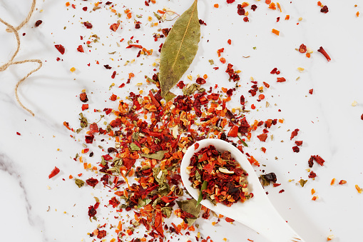 dried seasoning with pepper is scattered on a light background top view