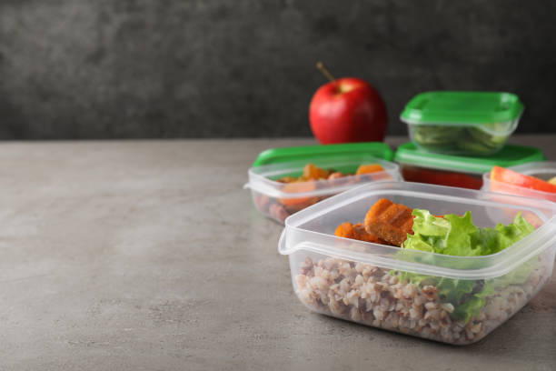 istock Set of plastic containers with fresh food on light grey table, space for text 1421201267