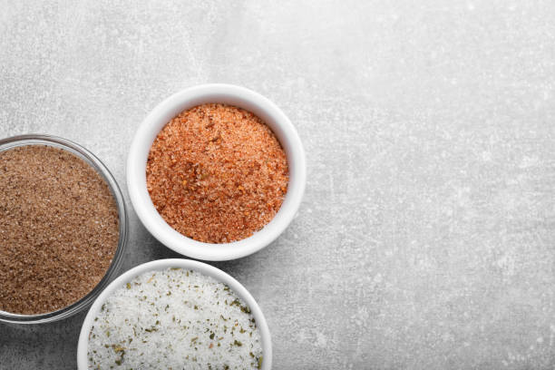 istock Different kinds of salt on grey table, flat lay. Space for text 1421201852