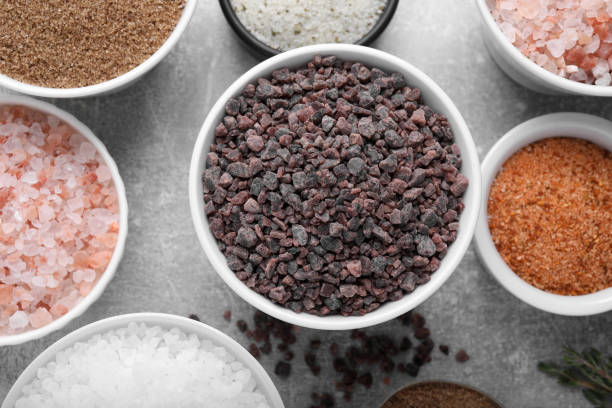 istock Different kinds of salt on grey table, flat lay 1421201896