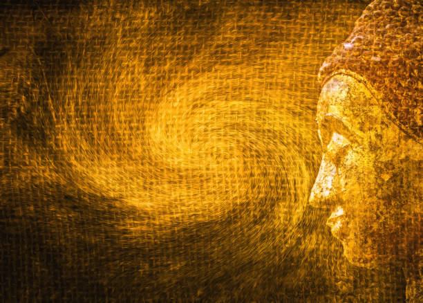 side view of golden buddha head on abstract golden texture background