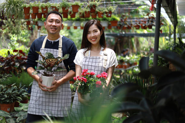 istock Plant nursery owners working in a garden center 1421202033
