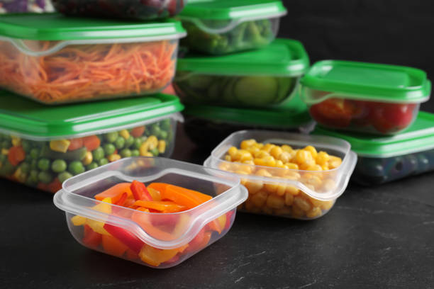 istock Set of plastic containers with fresh food on black table 1421202474