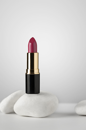 Pink lipstick on white background. Still life of glamour lipstick, decorative cosmetics.