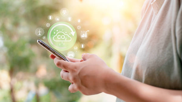 Industrial emissions pollute the environment and ecology. including climate change ,Carbon Reduction Agreement from Renewable Energy Reduce greenhouse gas emissions, young woman looking at smartphone