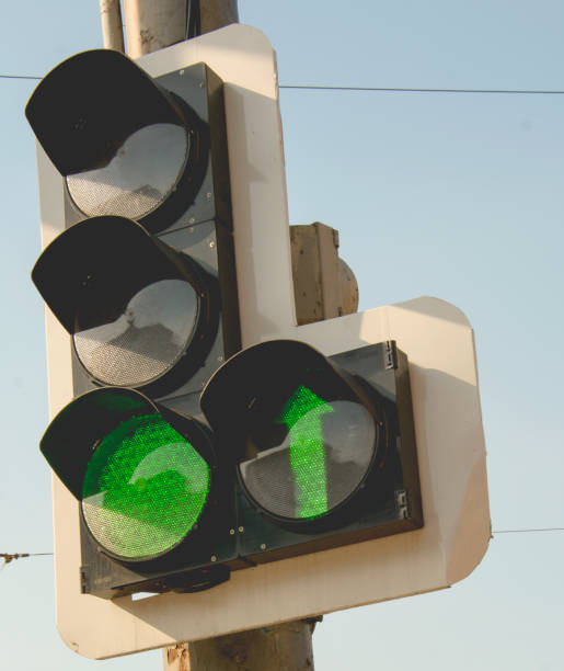istock A streetlight with a green light hangs over the road 1421209484
