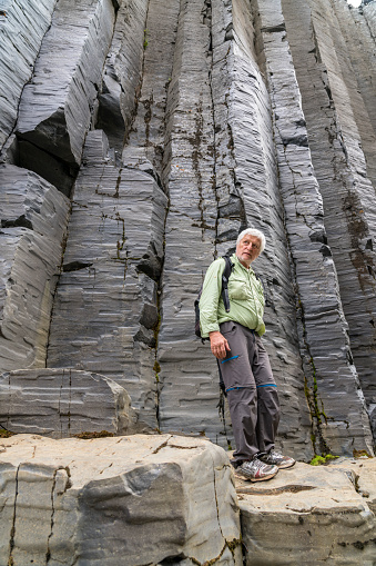 Senior man hiking at the basalt columns in Studlagil canyon, Jokuldalur Valley.