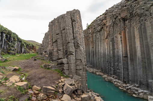 Basalt columns in Studlagil canyon and turquoise river, Jokuldalur Valley.