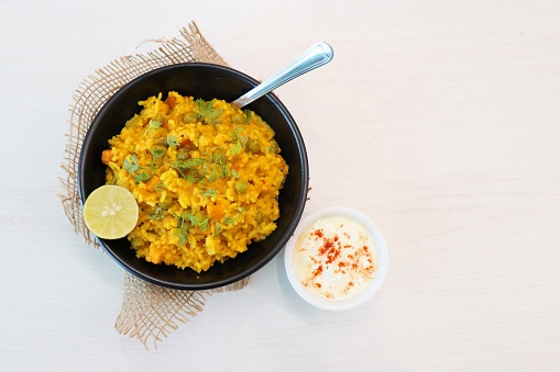 Dal khichadi or Masala Khichdi is a Tasty Indian recipe made of mixed Lentils & rice combined with onions, garlic, tomatoes, Carrots, Peas, cauliflower and beans. Served with Curd or Yogurt & lemon