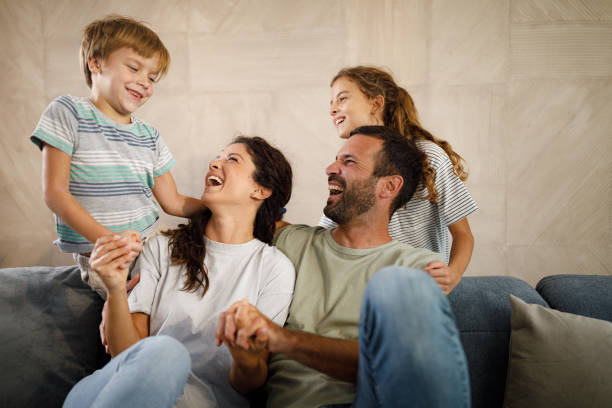 istock Cheerful family having fun while talking at home. 1421211515