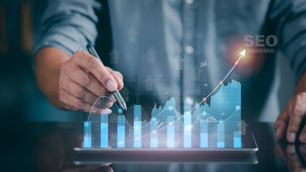 A marketer holds a pen pointing to a graph and shows SEO concepts, optimization analysis tools, search engine rankings, social media sites based on results analysis data. A marketer holds a pen pointing to a graph and shows SEO concepts, optimization analysis tools, search engine rankings, social media sites based on results analysis data. paper based equipment stock pictures, royalty-free photos & images