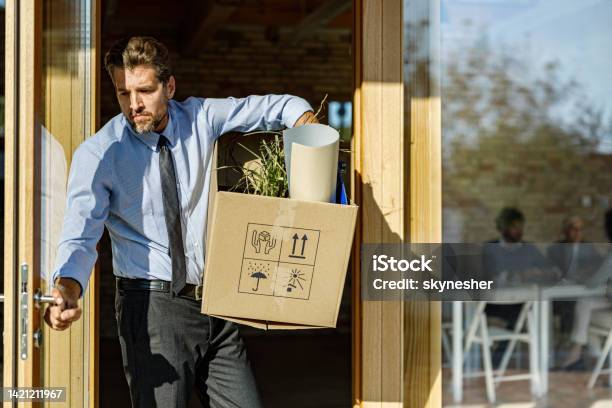 Depressed Businessman Leaving The Office After Being Fired From His Job Stock Photo - Download Image Now