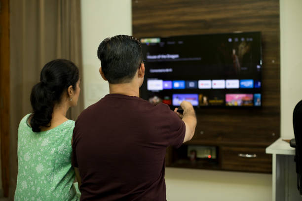 istock Couple watching tv in bedroom 1421219059