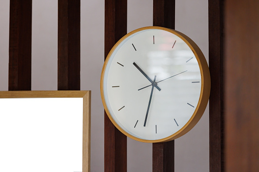 wooden clock on timber battens decoration in livingroom.
