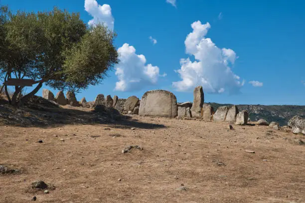 Photo of giants' tomb, (neolithic funerary graves), and standing stones. - sardinia - italy.