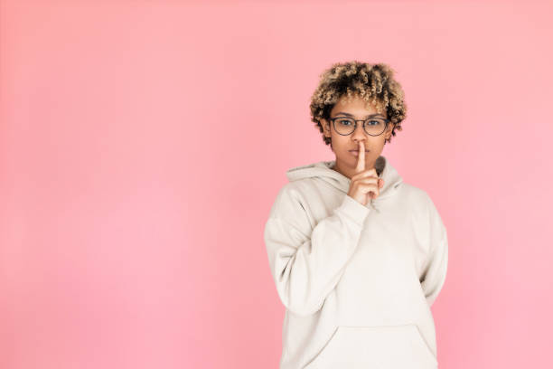 istock Serious woman in glasses calling be silent 1421223106