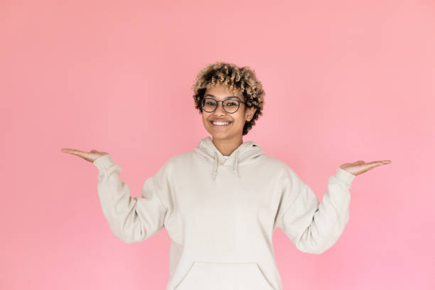 istock Woman pointing copy space with two hands 1421223459