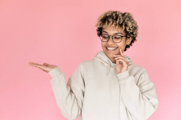 istock African American woman pointing copy space 1421224839
