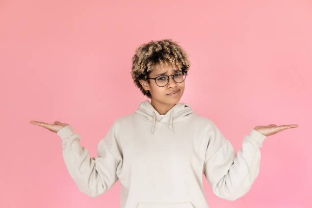 istock Frowning woman pointing copy space with two hands 1421225078