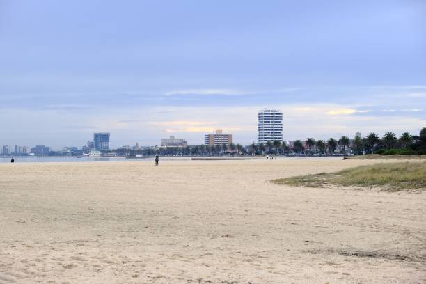istock Beautiful sandy beach with buildings in the background 1421225582