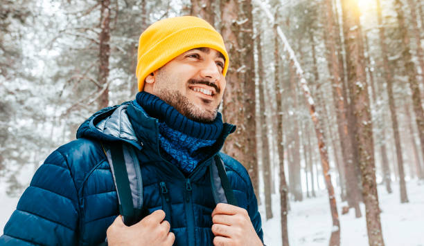 istock Young happy hiker man walking on snow 1421228225