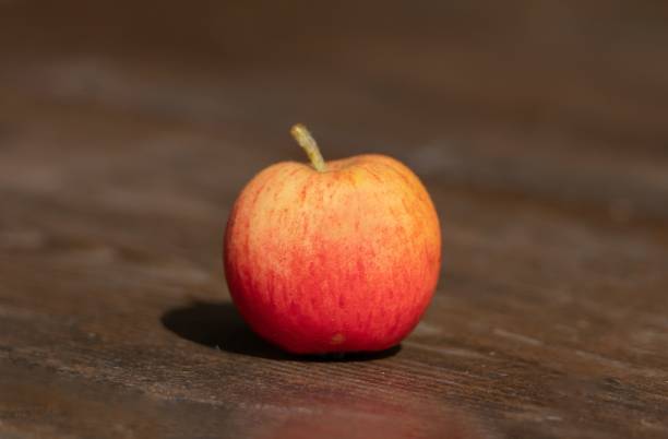 istock a close-up of a ripe apple on a board 1421229233
