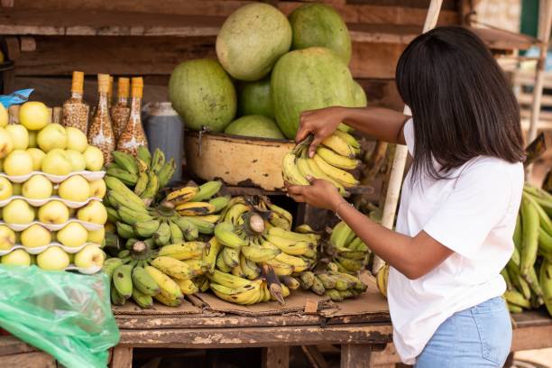 istock african lady shopping for fruits 1421231372