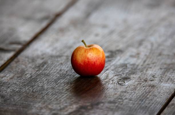 istock an isolated red apple on a plank in the foreground 1421231875