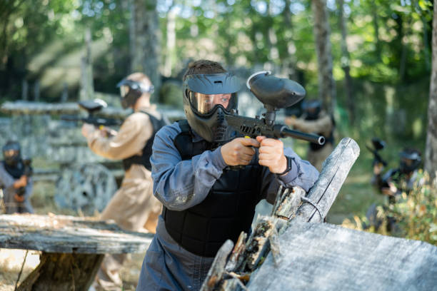 istock Paintball player recklessly aims with a gun on battlefield 1421232737