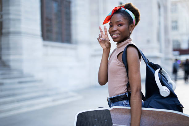 istock Beautiful African girl with skateboard. 1421233418