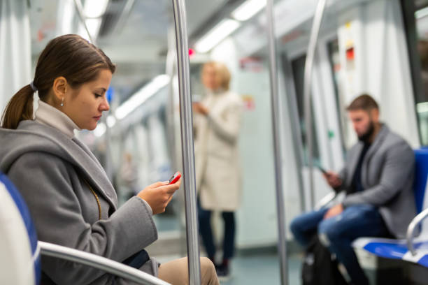 istock Woman with smartphone in subway car 1421233864