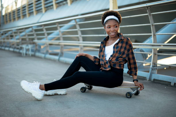 istock Beautiful African girl with skateboard. 1421233893