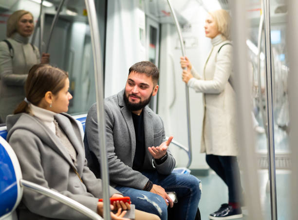 istock Happy passengers flirting in subway and smiling 1421234007