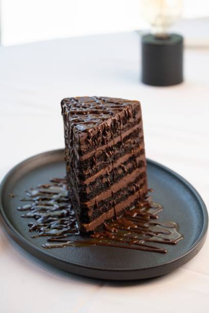istock Vertical shot of chocolate layer cake at fine dining restaurant 1421234817