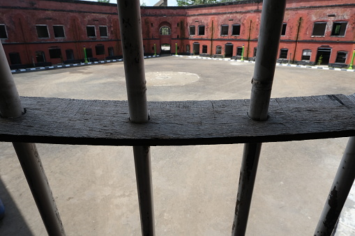 Jail bars with prison building in the background