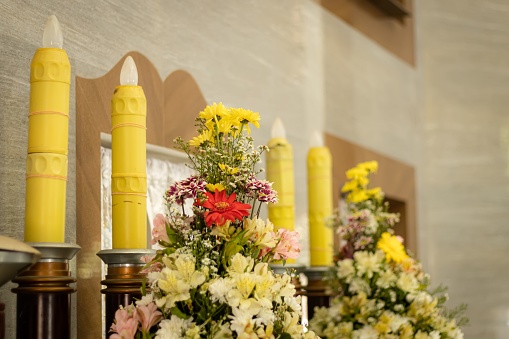 Decorated flowers and other candles and deco in a church interior