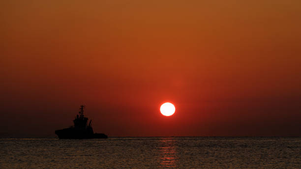 istock a ship leaving port at sunrise 1421238018
