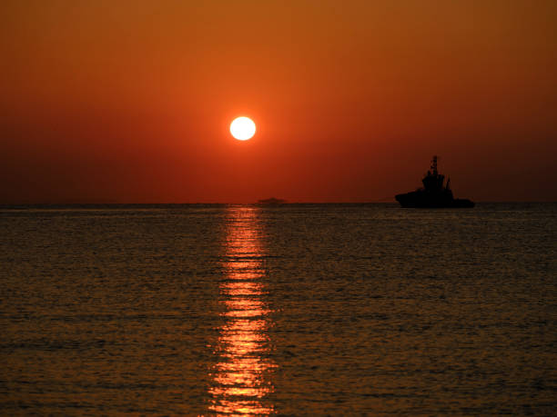 istock a ship leaving port at sunrise 1421238729