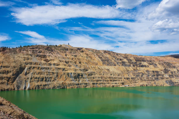 The Berkeley Pit, a former open pit copper mine located in Butte, Montana, is currently one of the largest Superfund sites that is filled with water that is heavily acidic.