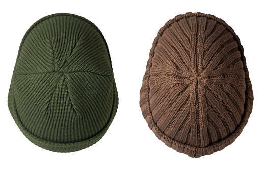 two docker knitted dark green and brown  hats isolated on white background. fashionable rapper hat. hat fisherman top view