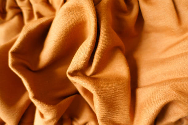istock Draped brownish orange hemp and cotton fabric 1421240825