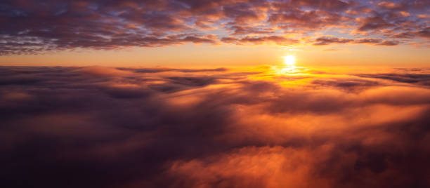 istock Wide panorama of clouds with setting sun on the background 1421241235