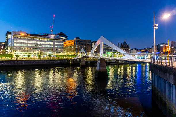 glasgow reino unido edificios modernos en la zona central de la ciudad con el río clyde y el puente ondulado en primer plano por la noche - glasgow clyde river river city fotografías e imágenes de stock