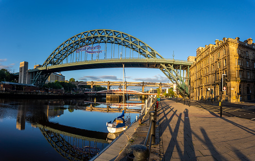 Newcastle United Kingdom panoramic view of the river Tyne with the iconic Tyne Bridge and a small yacht in the foreground