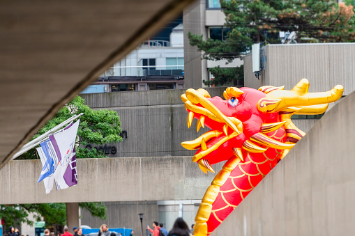 Toronto, Canada - September 4, 2022: A large decorative inflatable dragon is decorating Nathan Phillips Square during the annual festival named Toronto Dragon Festival