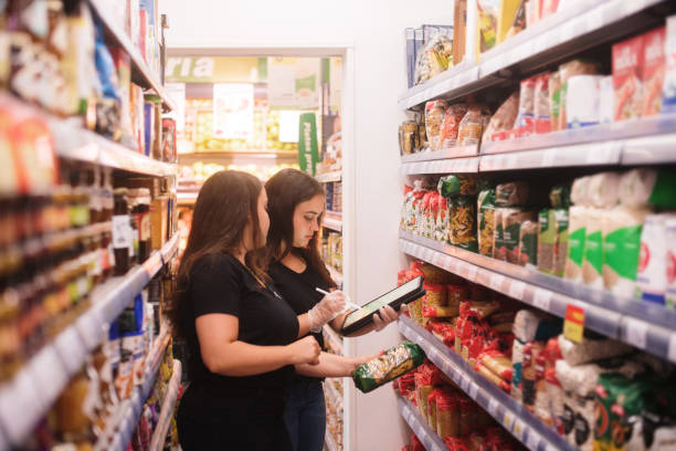 istock Two women working with a tablet in a grocery store 1421244704